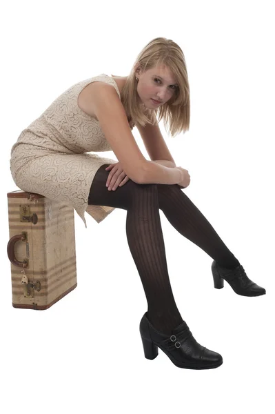 Teen girl sitting on a suitcase — Stock Photo, Image