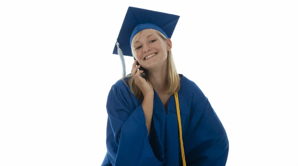 Graduating girl in gown on cell phone — Stock Photo, Image