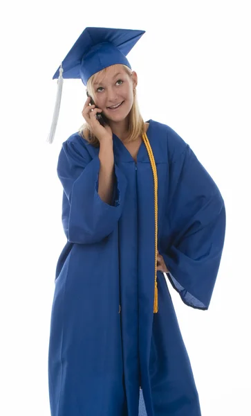 Graduating girl in gown on cell phone — Stock Photo, Image