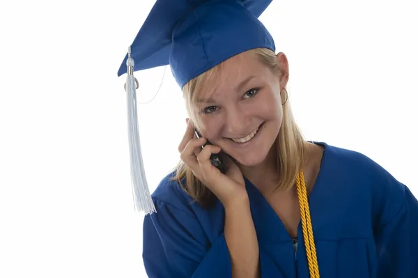 Graduating girl in gown on cell phone — Stock Photo, Image