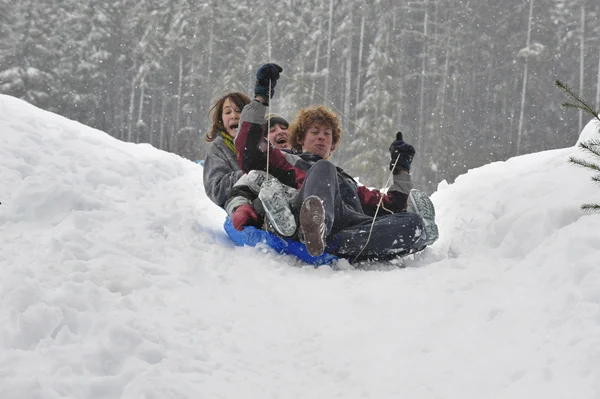 Teens sledding on a saucer — Stock Photo, Image