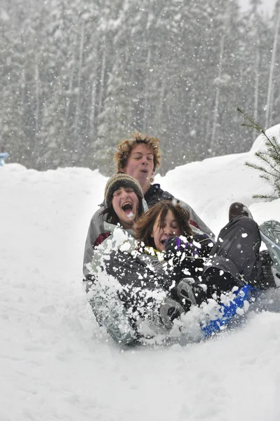 Teens sledding on a saucer — Stock Photo, Image