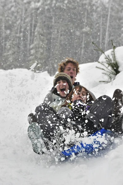 Teens sledding on a saucer — Stock Photo, Image