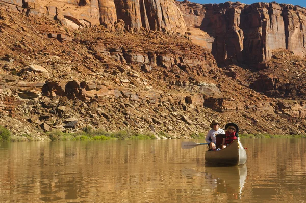 Canoe on desert river, mother and daughter