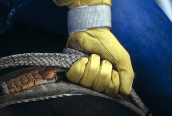 Glove of rodeo cowboy gripping rope — Stock Photo, Image