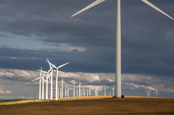 Wind turbines below a stormy sky