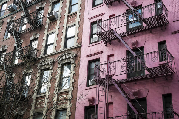 Pink apartment building with fire escapes, New York City