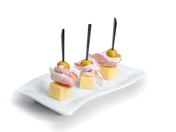 Tabağa dizilmiş bir sürü renkli kanepe var. Beyaz bir fuayede beyaz bir meşalede kanapeler