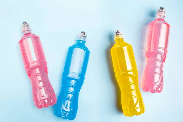 Plastic bottles with colored liquid. Colored bottles of sports nutrition, isotonics.