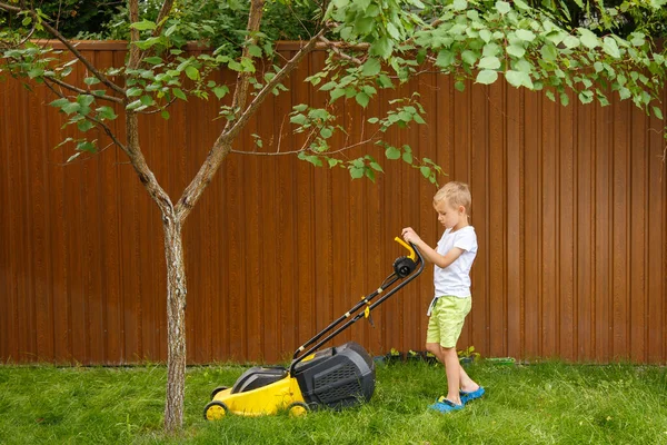 Blond Boy Mowing Lawn Garden Yellow Lawn Mower Sunny Summer — Photo