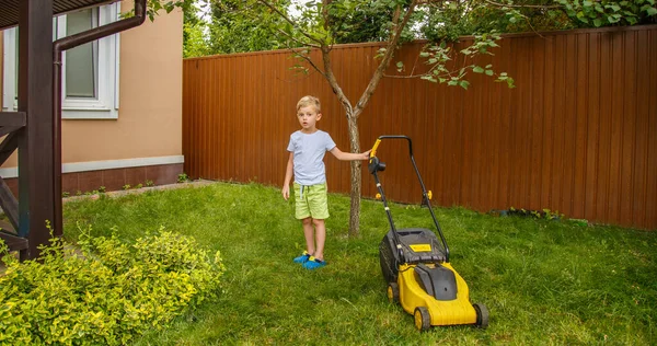 Blond Boy Mowing Lawn Garden Yellow Lawn Mower Sunny Summer — Photo