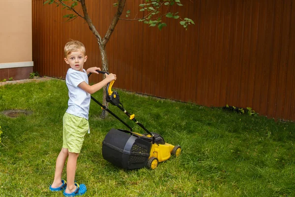 Blond Boy Mowing Lawn Garden Yellow Lawn Mower Sunny Summer — Photo