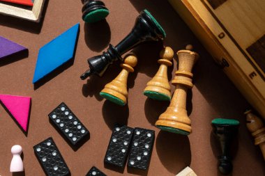 Chess board and chess pieces. desktop games, on the brown table. Home entertaiment, indoor games