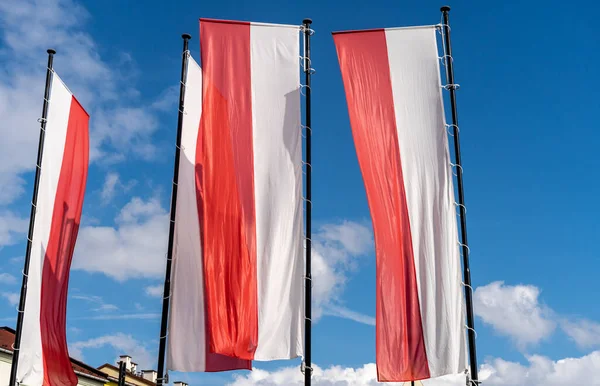 Poland flags on blue sky background