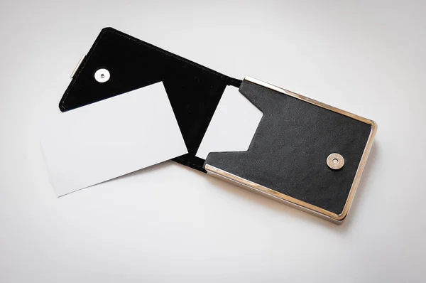 A business card and a black card holder on white background — Stock Photo, Image