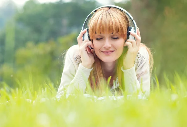Piękna młoda kobieta ze słuchawkami — Zdjęcie stockowe