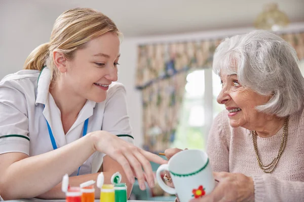 Senior Vrouw Schilderen Beker Met Vrouwelijke Kunst Therapeut — Stockfoto