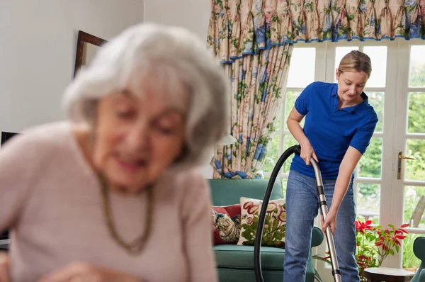 Female Home Help Cleaning House Vacuum Cleaner Talking Senior Woman — Stock Photo, Image