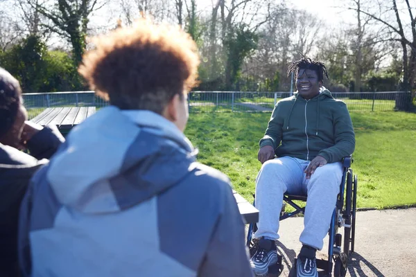 Tekerlekli Sandalyedeki Genç Çocuk Parkta Arkadaşlarıyla Takılıyor Konuşuyor Gülüyor — Stok fotoğraf