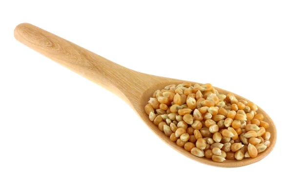 Uma tigela de madeira cheia de grãos de milho amarelo seco — Fotografia de Stock