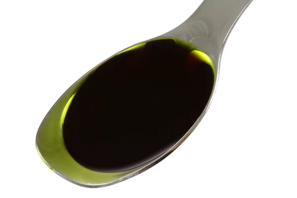 Uma colher cheia de óleo de semente de abóbora — Fotografia de Stock