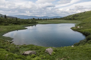 The bowl of a mountain lake surrounded by forests and peaks, Carpathians