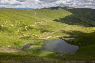 A sunny day in a green mountain meadow with lake, Svydovets, The Carpathians, Ukraine.