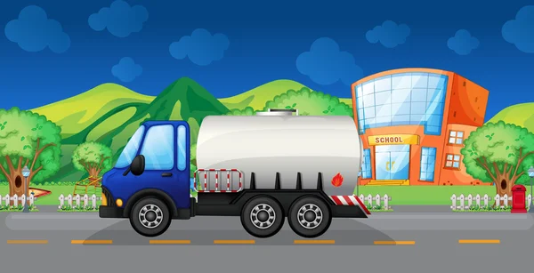 An oil truck passing a school — Stock Vector