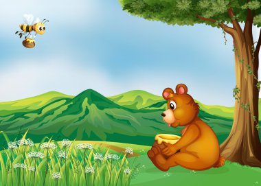 bir ağacın yanında oturan bir ayı