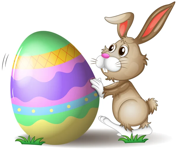 Un coniglio che spinge un uovo di Pasqua — Vettoriale Stock