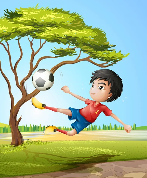 Un chico jugando al fútbol en la carretera — Vector de stock