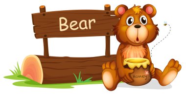 ahşap tabela yanında bal tutan bir ayı