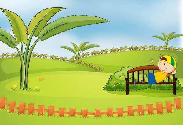 A boy lying at the bench inside the fence — Stock Vector