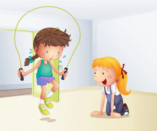 En flicka som leker hoppa rep inne i rummet — Stock vektor
