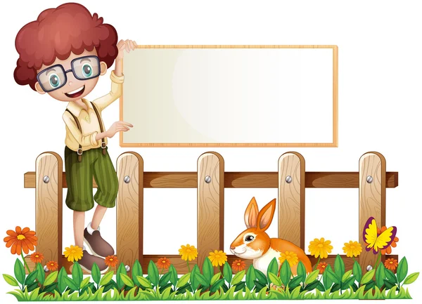 A boy at the fence holding an empty board — Stock Vector