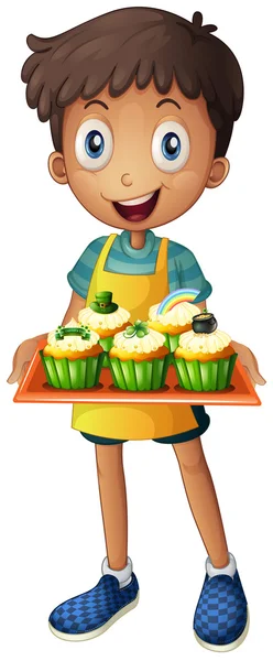 A young man holding a tray with cupcakes — Stock Vector