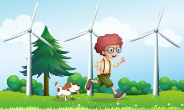 bir köpeğin yanına üç yel değirmenleri ile çalışan bir çocuk