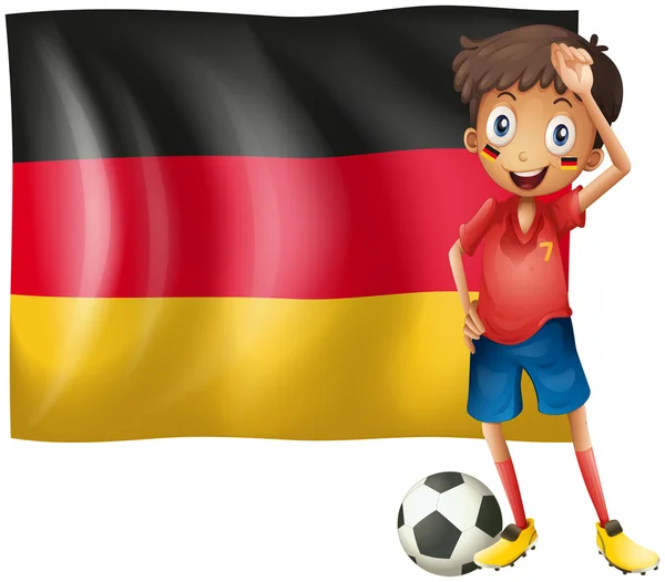 Ein Junge mit einem Fußball vor der Fahne von Deutschland — Stockvektor