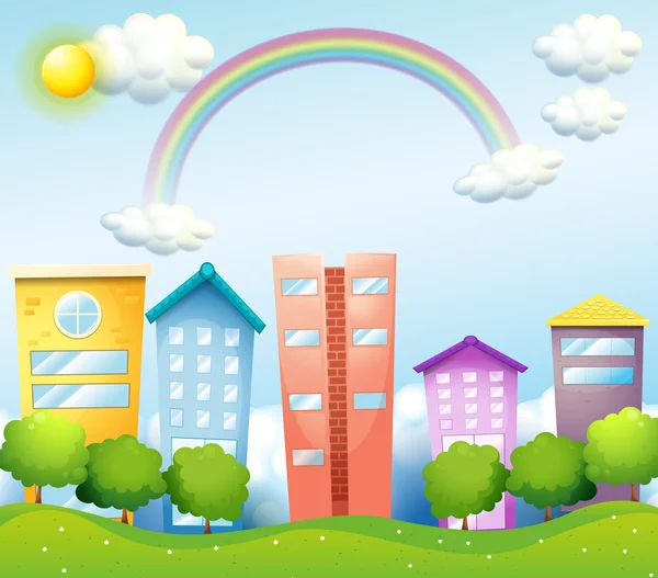 A rainbow above the tall buildings — Stock Vector