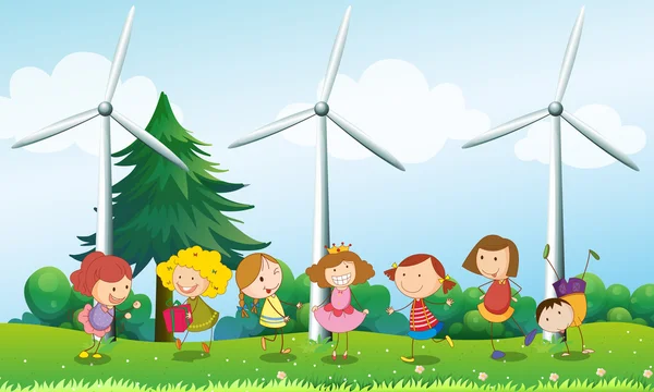 Seven kids playing in the hill with three windmills — Stock Vector