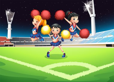 Üç cheerdancers futbol alanında gerçekleştirme