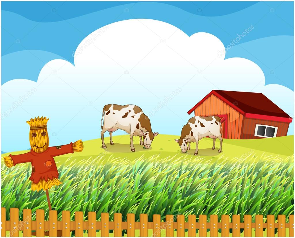 A scarecrow with two cows inside the fence