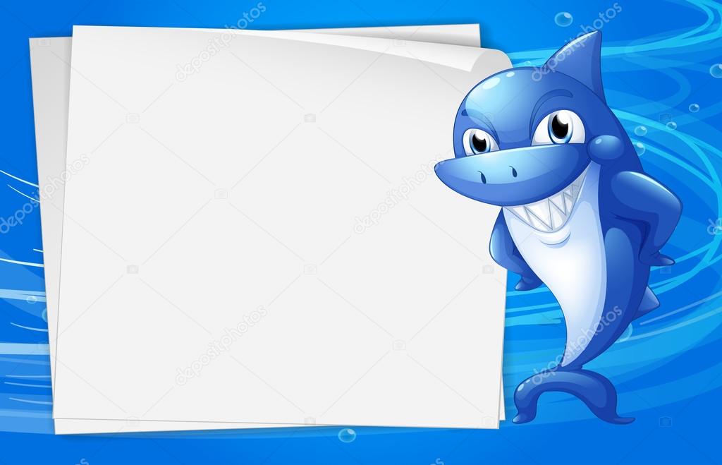 A blue shark beside an empty paper under the water