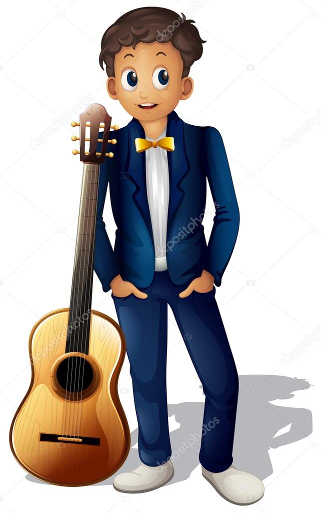 A boy standing beside the guitar