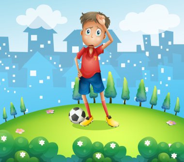 tepenin üstündeki yorgun bir futbolcu