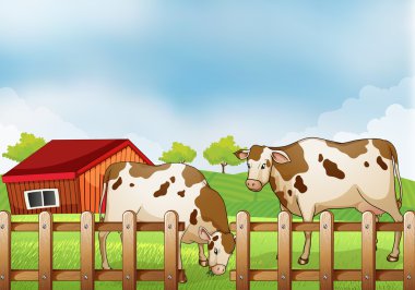 A farm with two cows inside the fence clipart
