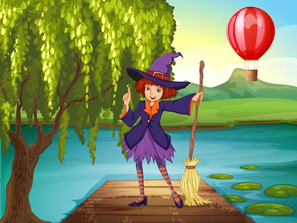 A witch holding a broom standing at the port — Stock Vector