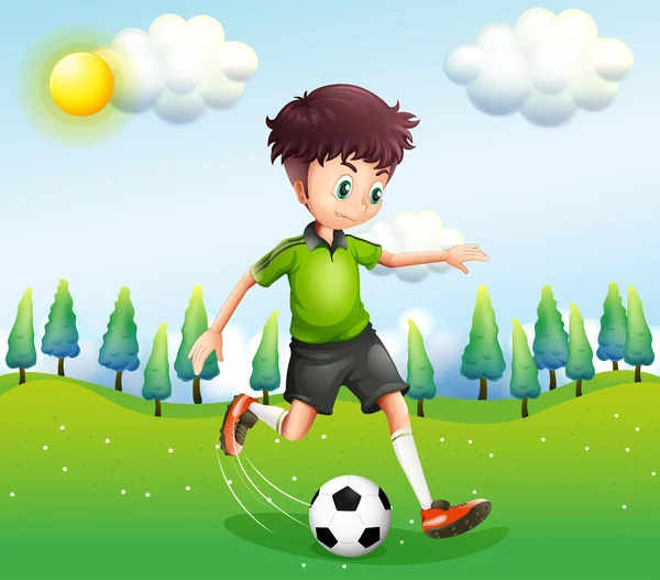 Um rapaz a jogar futebol na colina —  Vetores de Stock