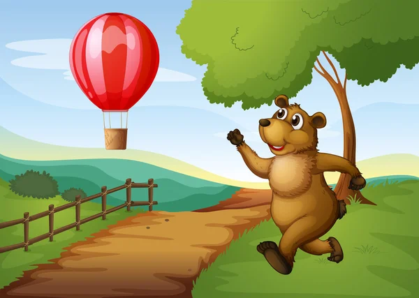 A bear running after the hot air balloon — Stock Vector