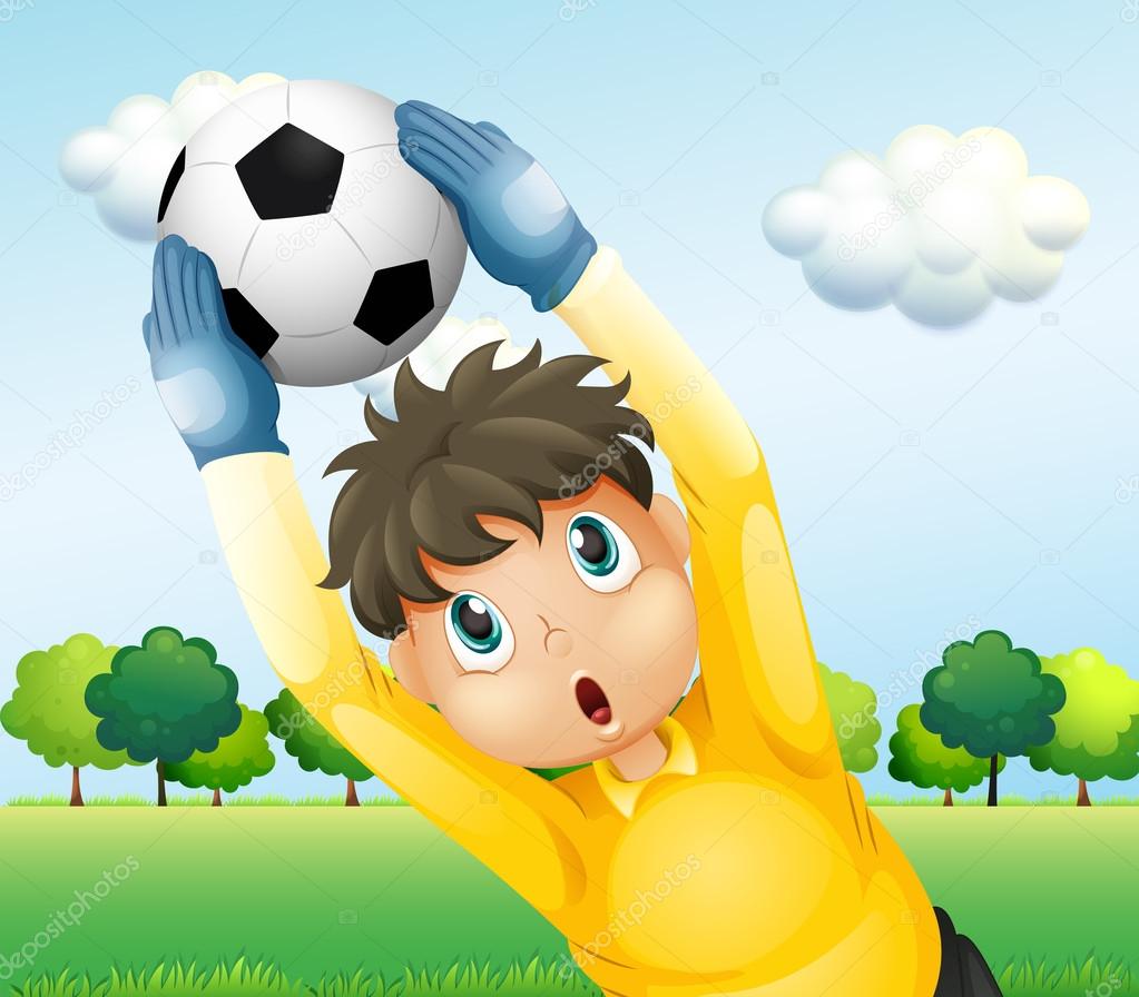 A boy playing soccer with a yellow uniform